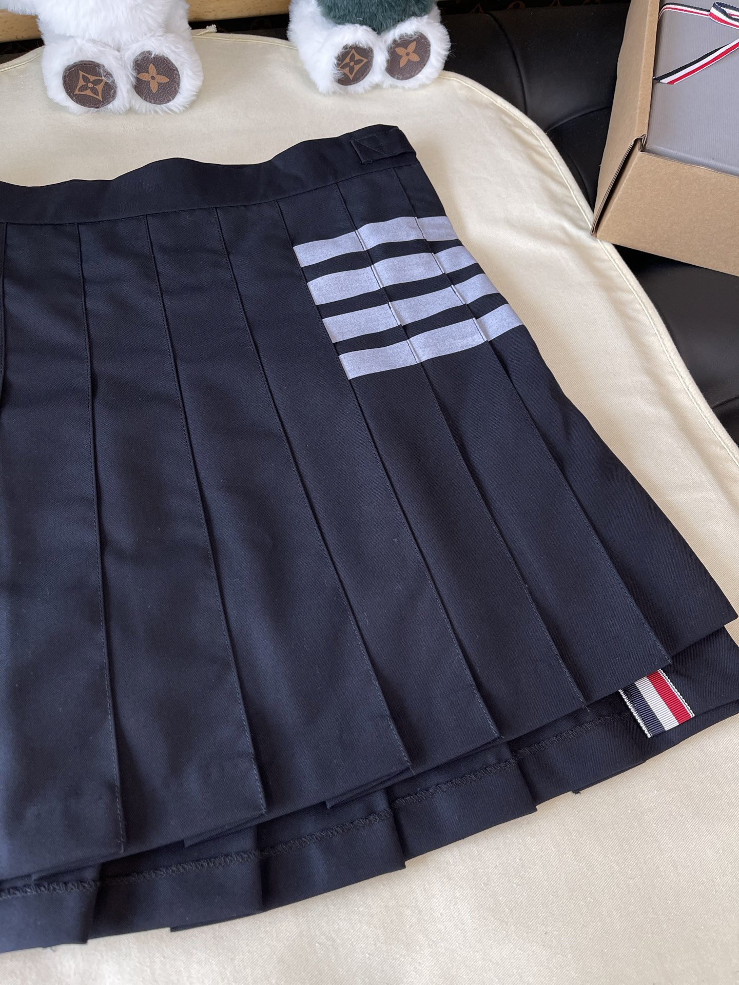 Four-Bar Layered Pleated Skirt — product photograph