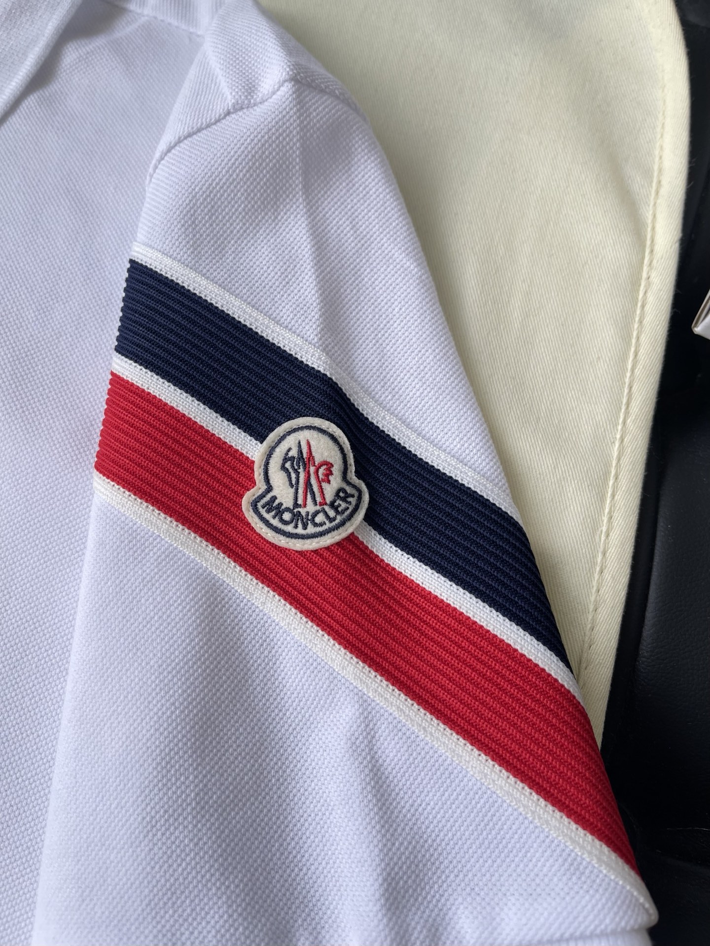 Stripe-Sleeve Badge Polo — product photograph
